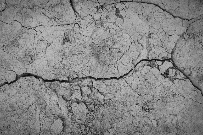 Gray cracked concrete texture background, close up